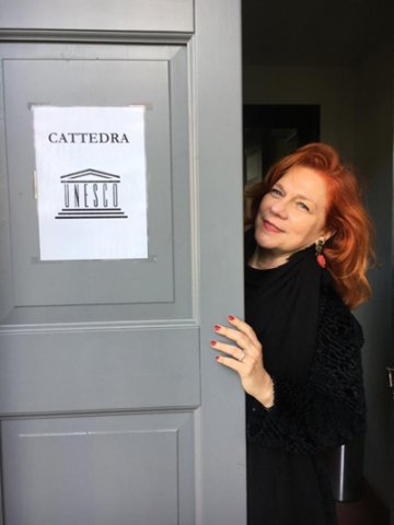 La professoressa Barbara Pozzo sulla soglia di un ufficio con il logo della Cattedra UNESCO