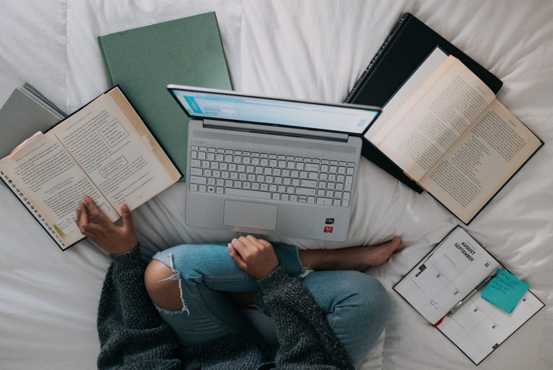 Foto di copertina, ragazza che studia con PC e libri